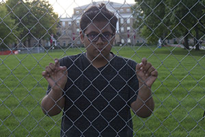 picture of Divij behind a fence